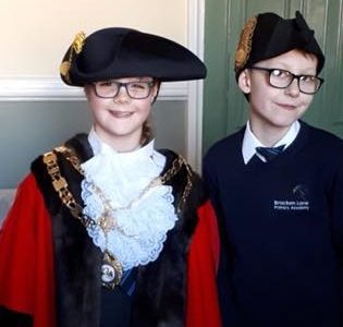 Pupils raise the Commonwealth Flag